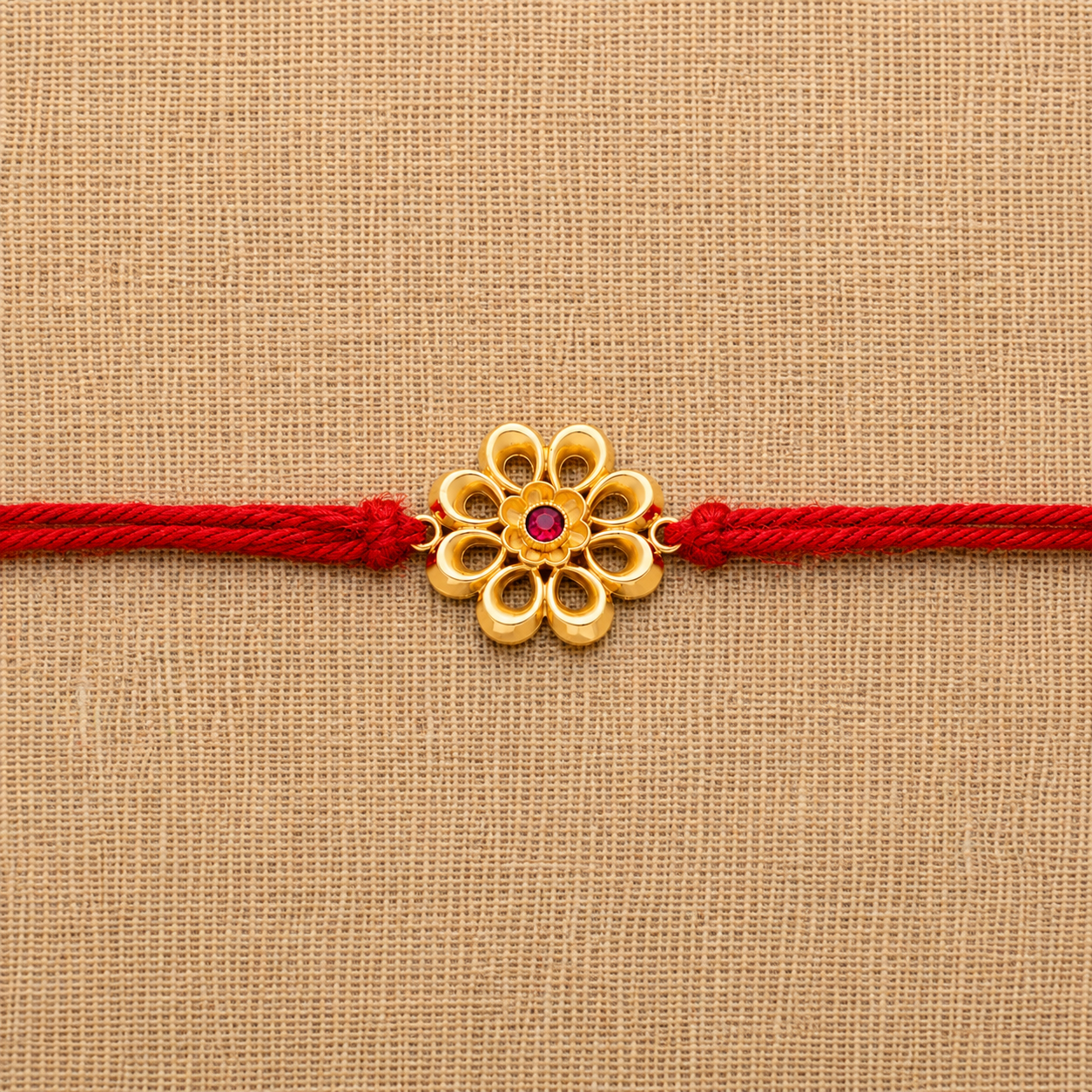 22k-gold-floral-rakhi-red-thread