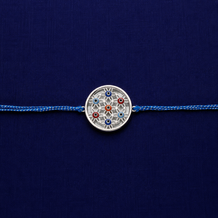Silver rakhi with premium blue thread and circular designer charm