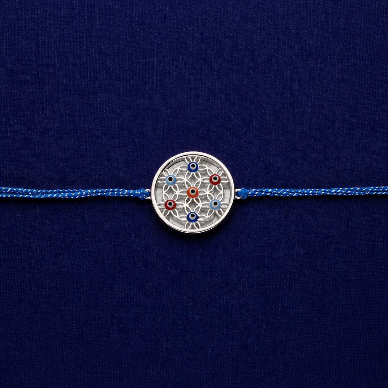 Silver rakhi with premium blue thread and circular designer charm
